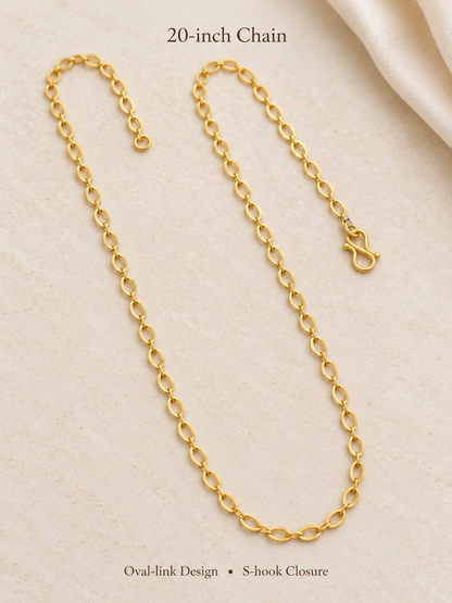 20 inch gold plated oval link chain with S-hook closure on cream fabric