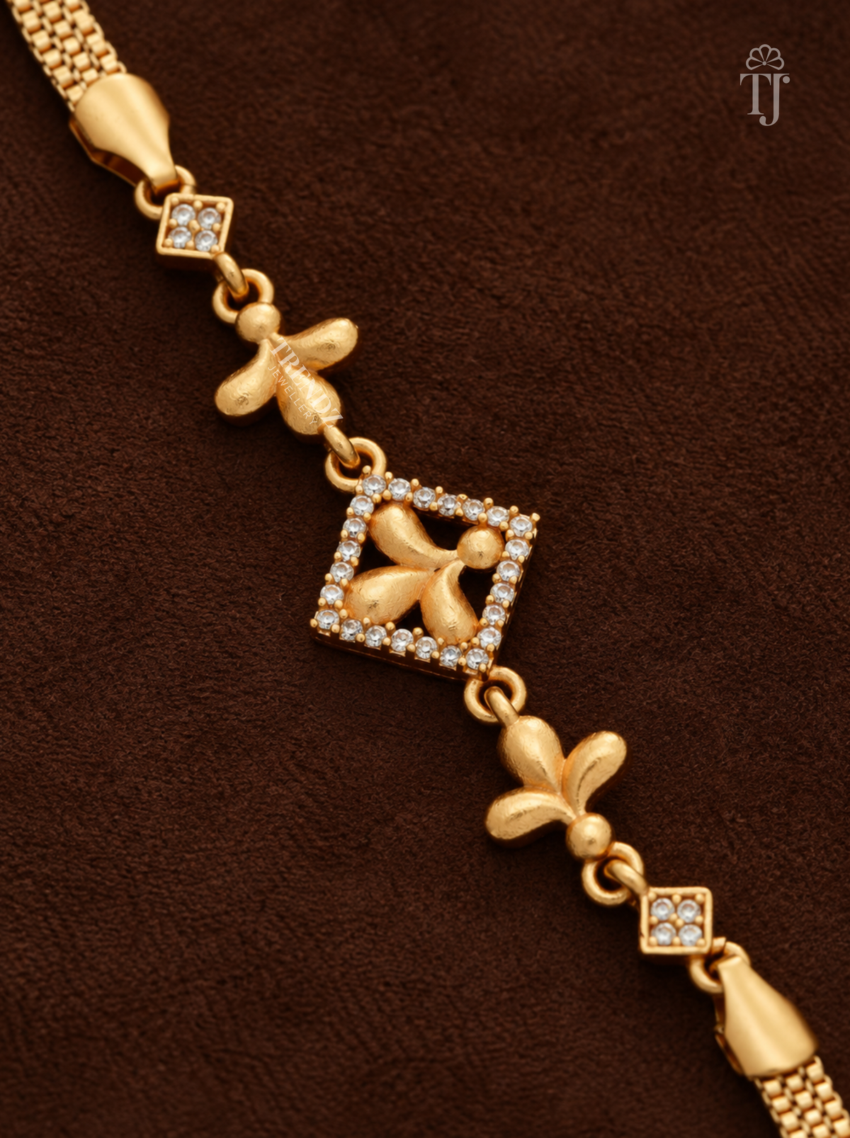 Close-up of square charm with white AD stone border and three-petal gold flower