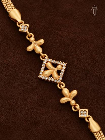 Close-up of square charm with white AD stone border and three-petal gold flower