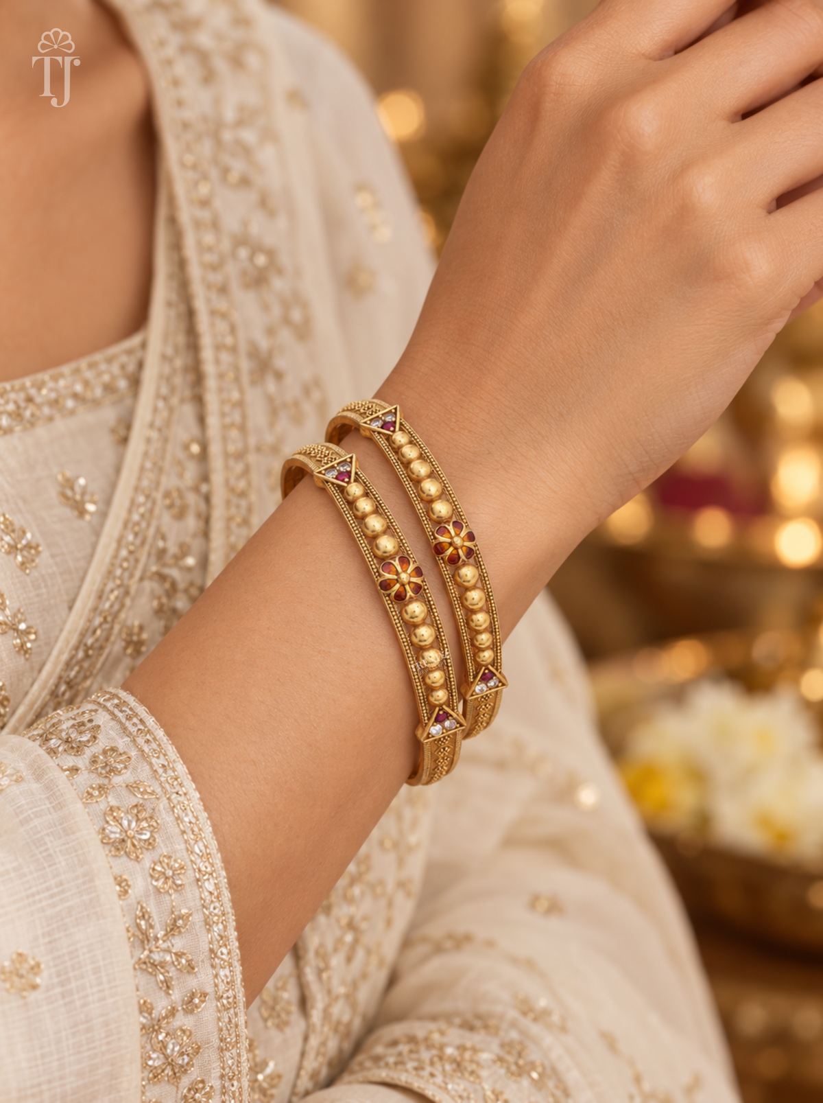Close-up of antique finish beaded artificial bangles with meena flower worn on wrist, festive outfit