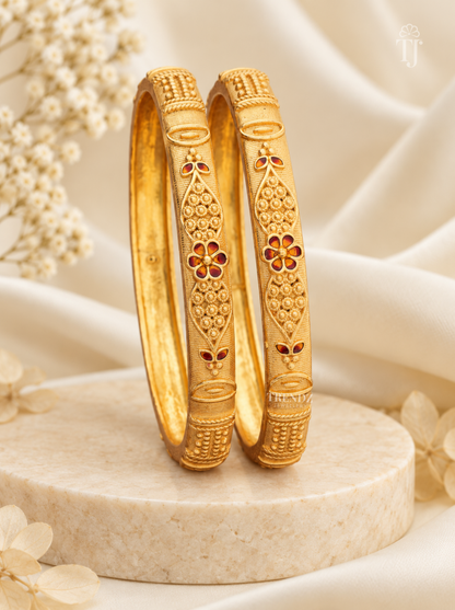 Antique finish artificial bangles for women with maroon meena flower, gold plated brass, pair on pedestal stand