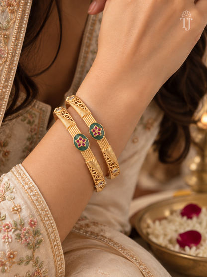 Green enamel pink star artificial bangles worn with festive saree sleeve