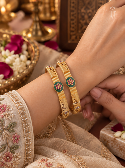Woman wearing green enamel pink star artificial bangles on wrist, festive outfit