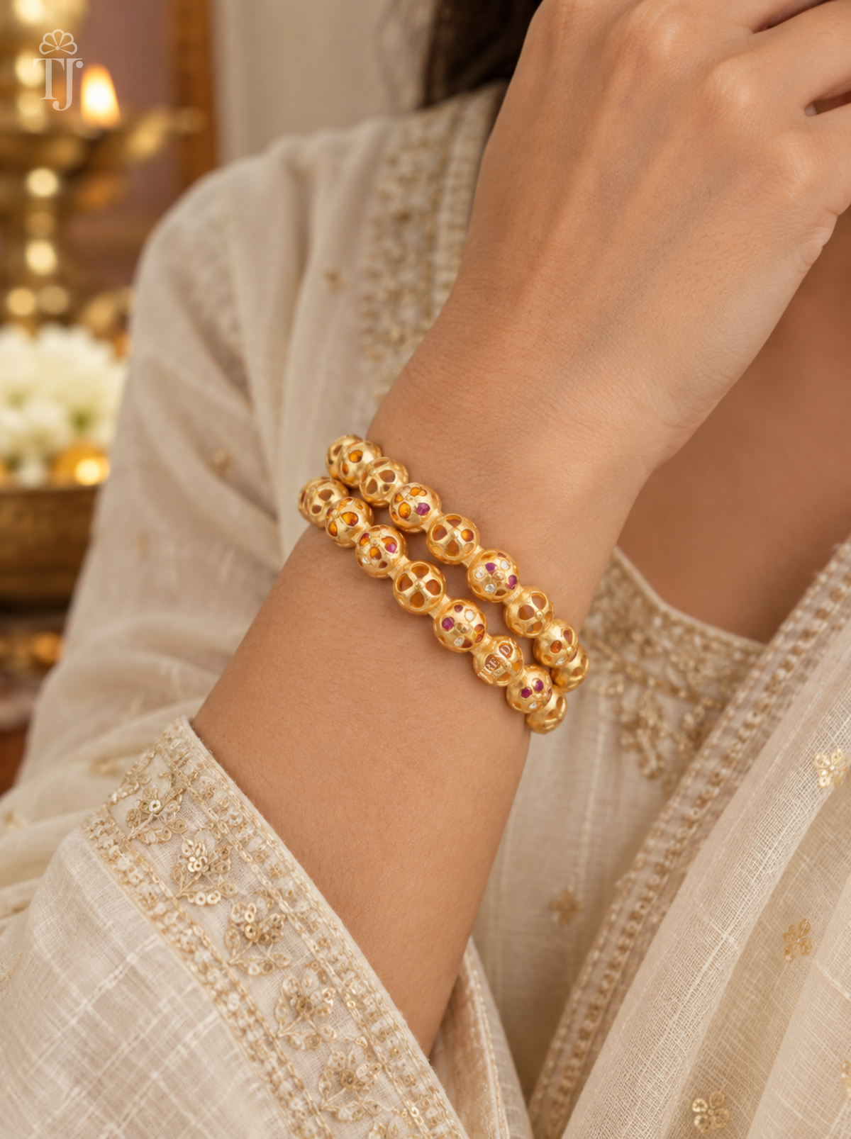 Woman wearing orange pink stone beaded artificial bangles, festive outfit