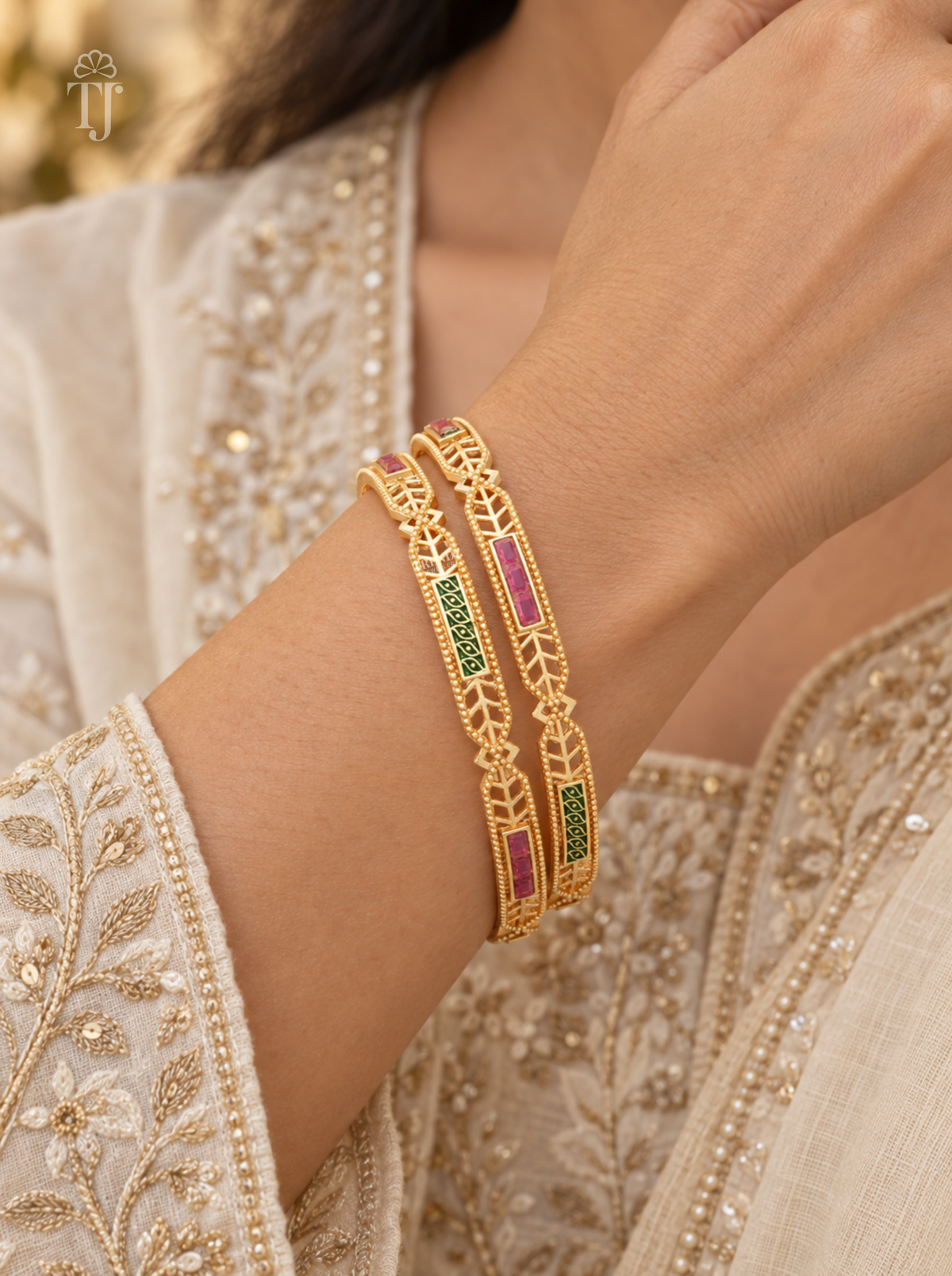 Woman wearing pink green stone artificial bangles with leaf design, festive outfit