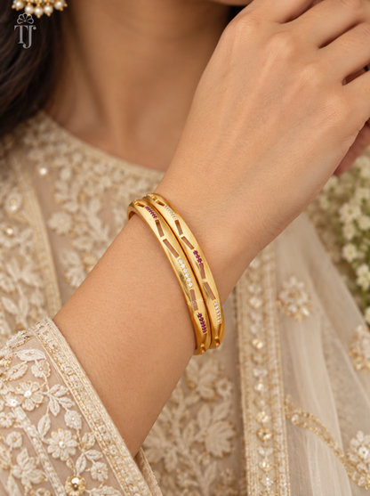 Woman wearing pink white stone cutout artificial bangles, festive outfit