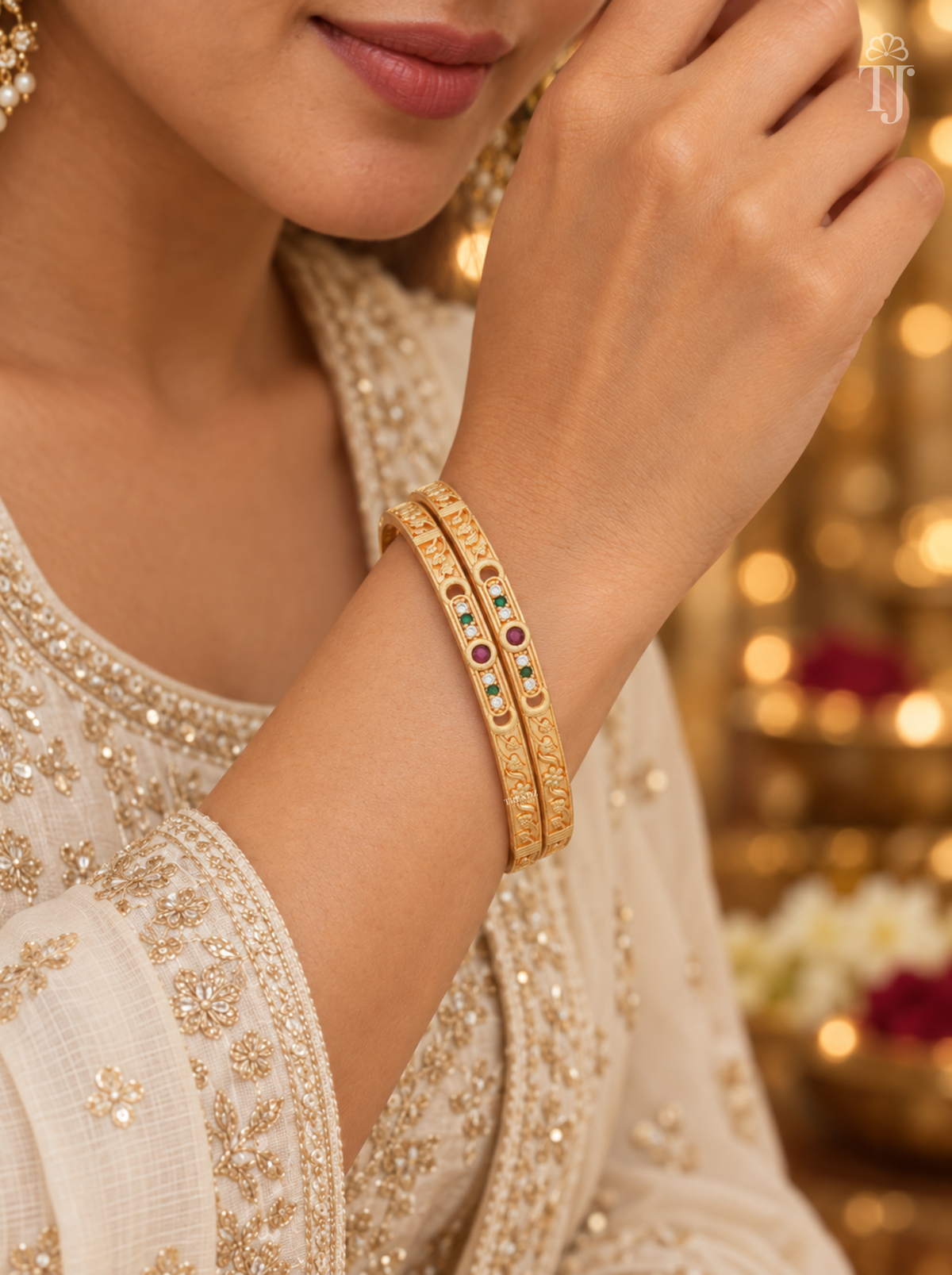 Lightweight thin gold plated bangles with red and green stones, worn on wrist, festive sleeve