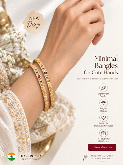 Red green white stone thin artificial bangles for women, gold plated brass, pair on warm backdrop

