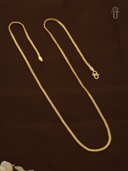 Artificial chain for girls with thin gold plated box links and S-hook on brown fabric