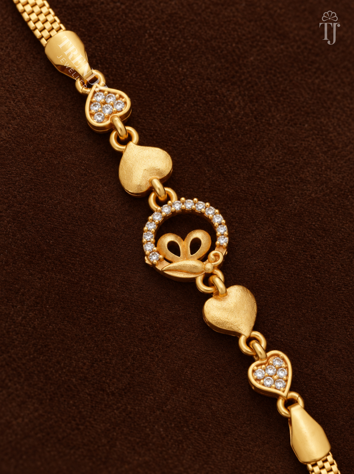 Close-up of gold butterfly in white AD stone ring with textured and stone-set heart links