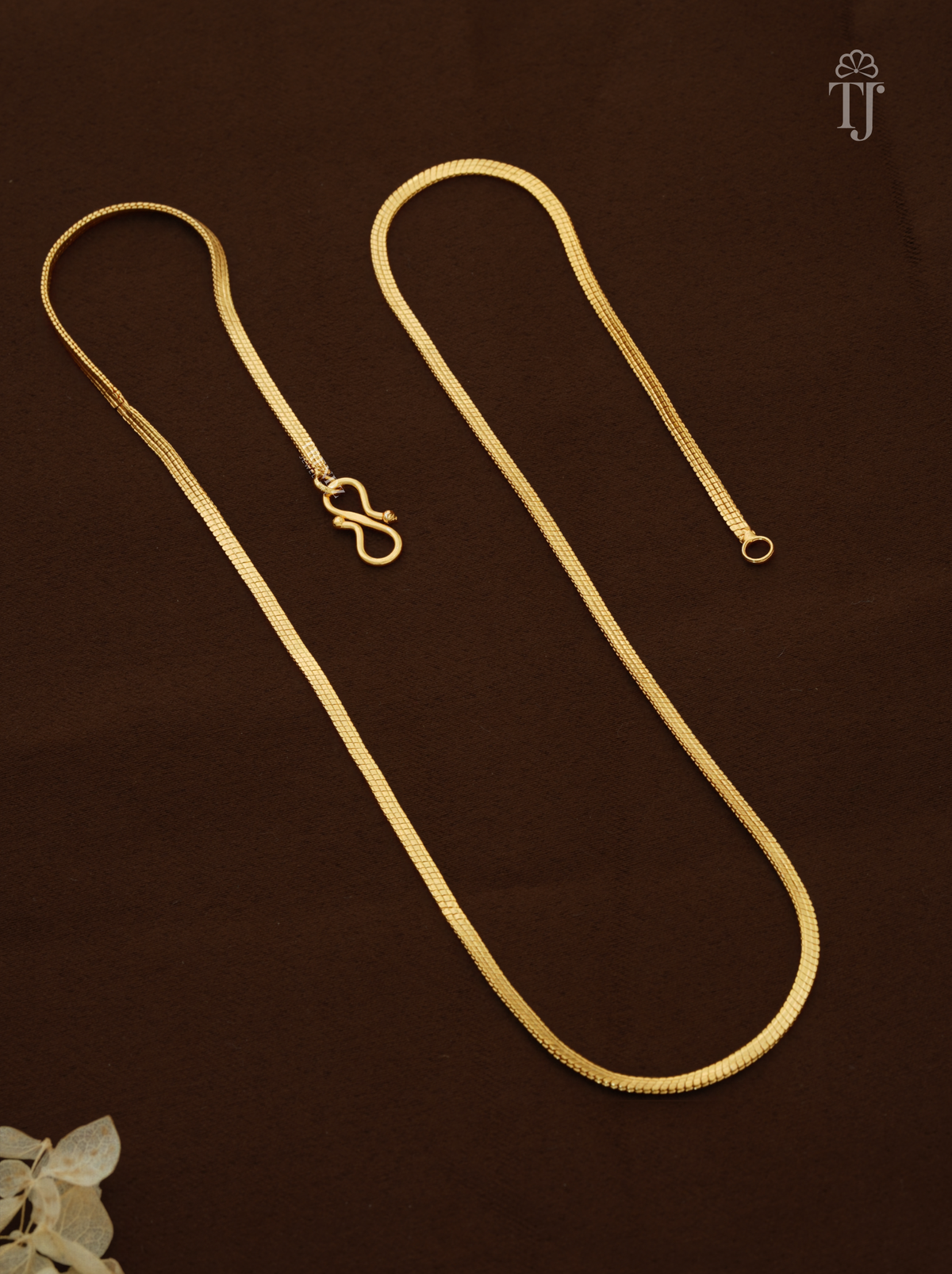 Chain designs for women and girls, gold plated snake chain with S-hook on brown fabric