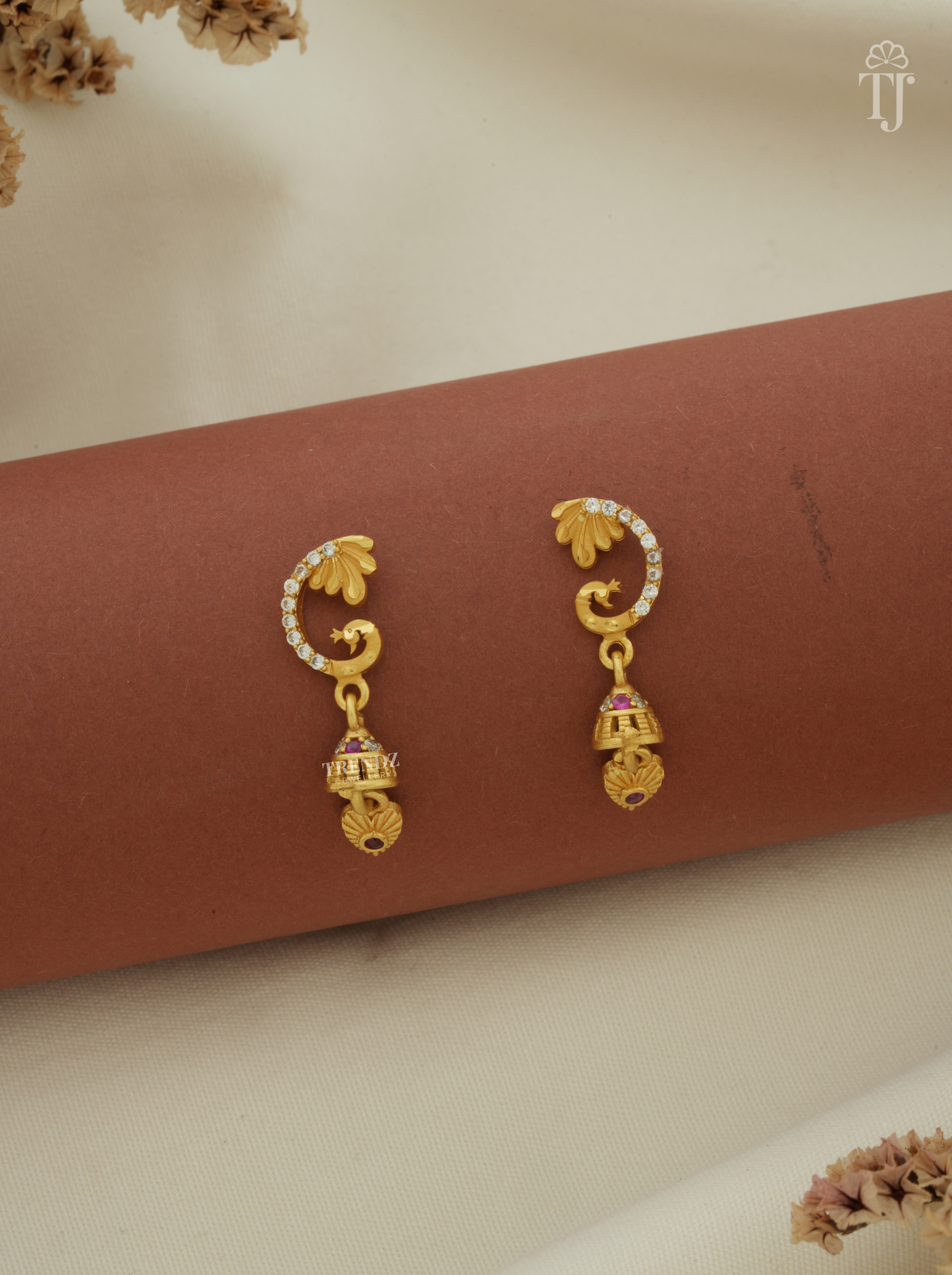 Charming gold bell drop earrings with peacock design and AD stones, gold plated