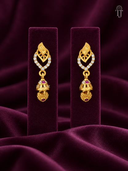 Gold plated double leaf jhumka earrings with AD stones on plum velvet display stand