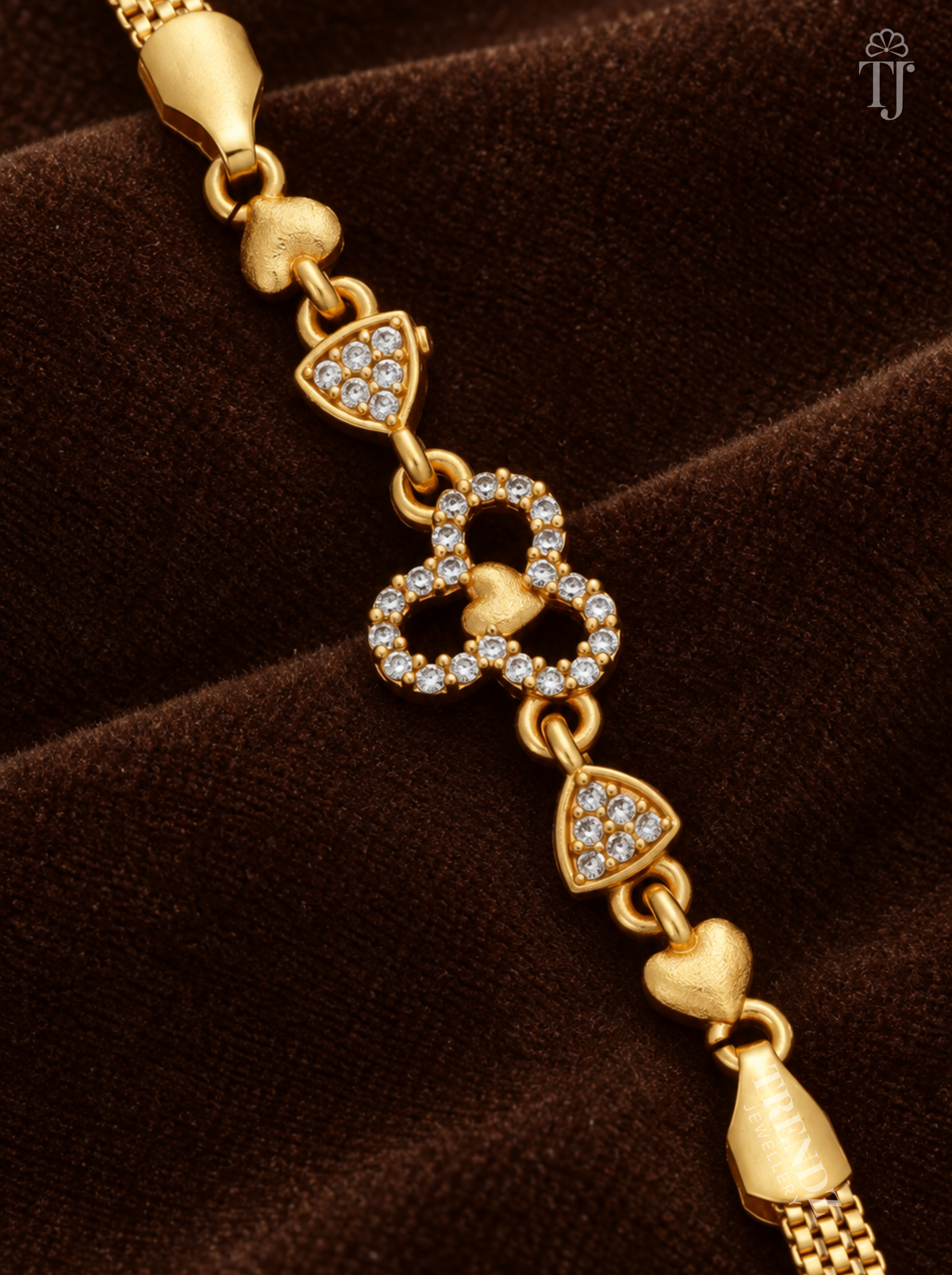 Close-up of three joined AD stone rings with gold heart centre and triangle stone links