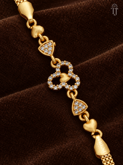Close-up of three joined AD stone rings with gold heart centre and triangle stone links