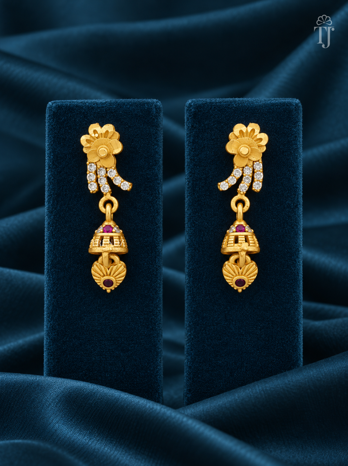 Gold plated flower drop earrings with AD stones on teal velvet display stand