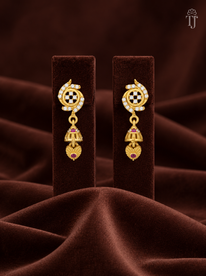 Gold plated stone flower jhumka earrings on brown velvet display stand