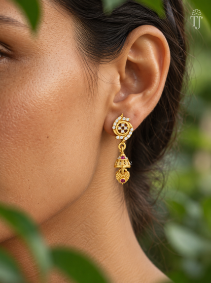 Side view of woman wearing gold plated stone flower jhumka drop earrings