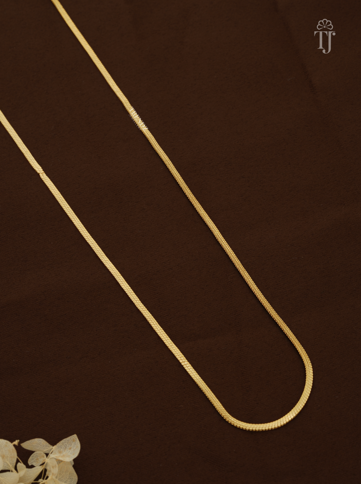 Close view of smooth thin gold plated snake chain