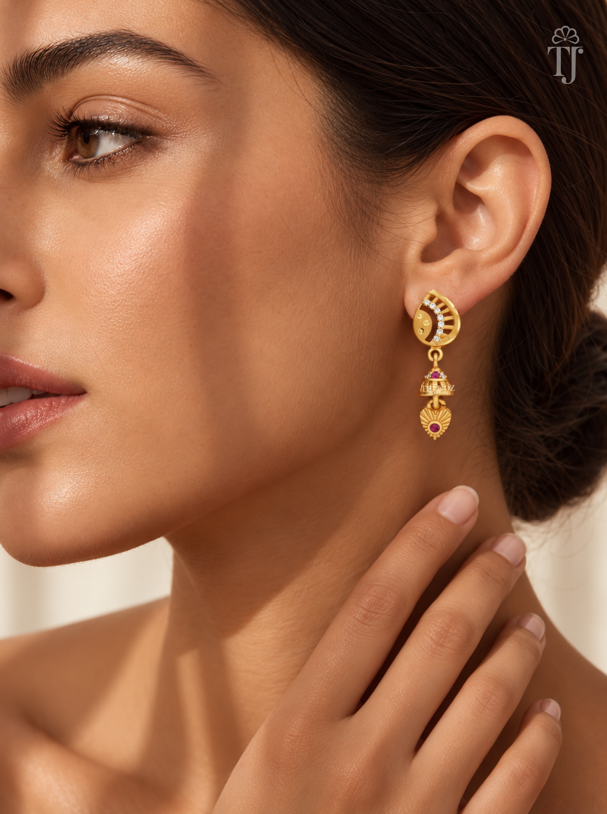 Woman wearing small gold plated half moon jhumka earrings with AD stones