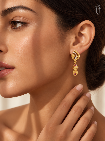 Woman wearing small gold plated half moon jhumka earrings with AD stones