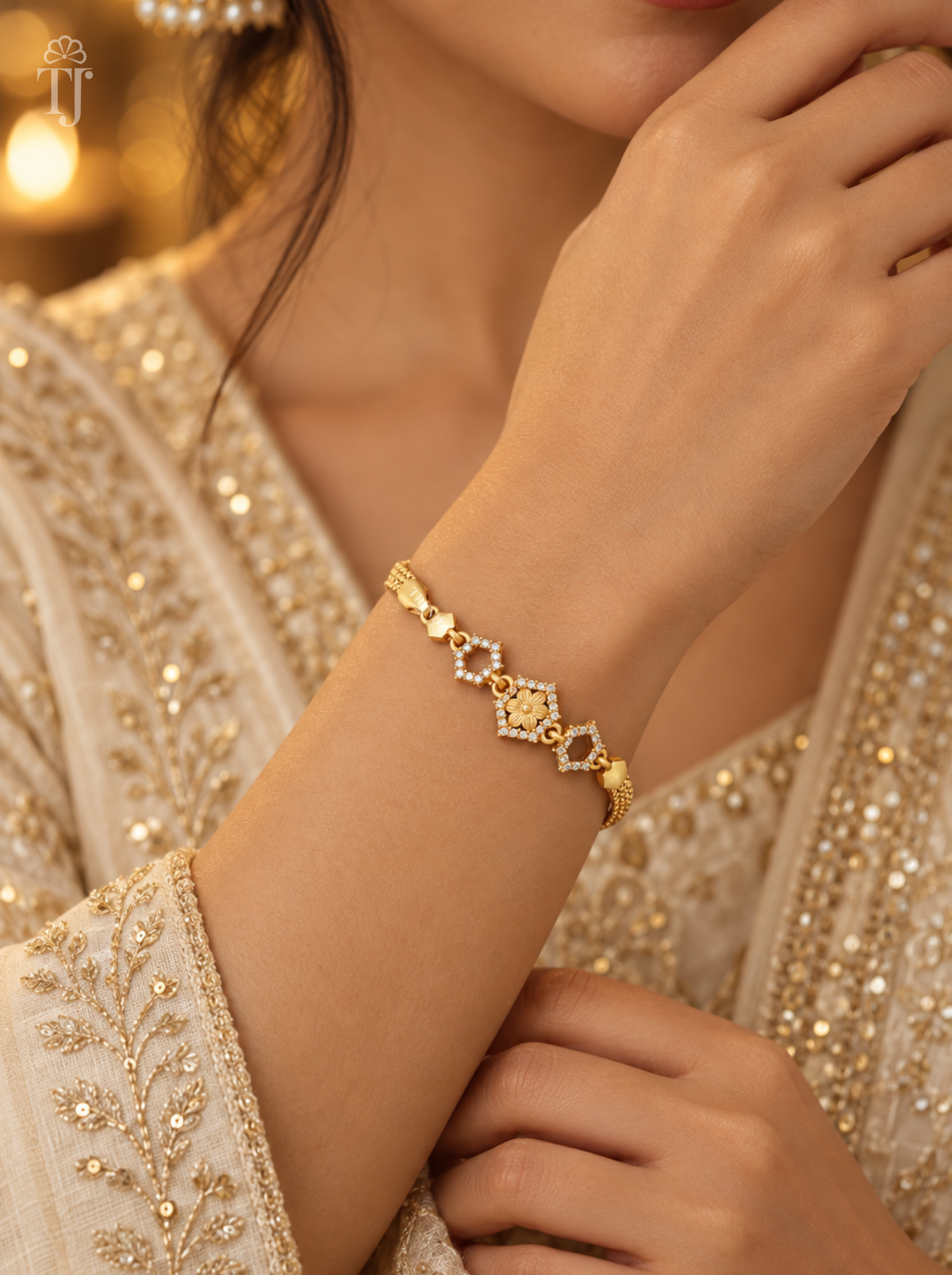 Woman in beige embroidered outfit wearing gold plated hexagon flower bracelet on her wrist