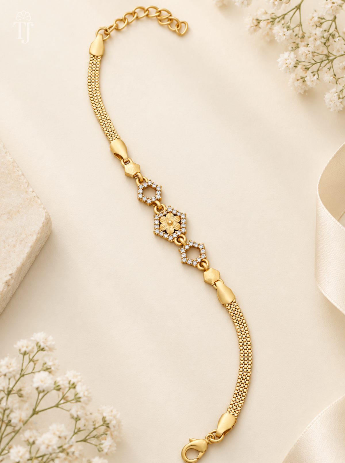 Latest ladies bracelet design, gold plated with hexagon flower charm and white AD stones on cream background