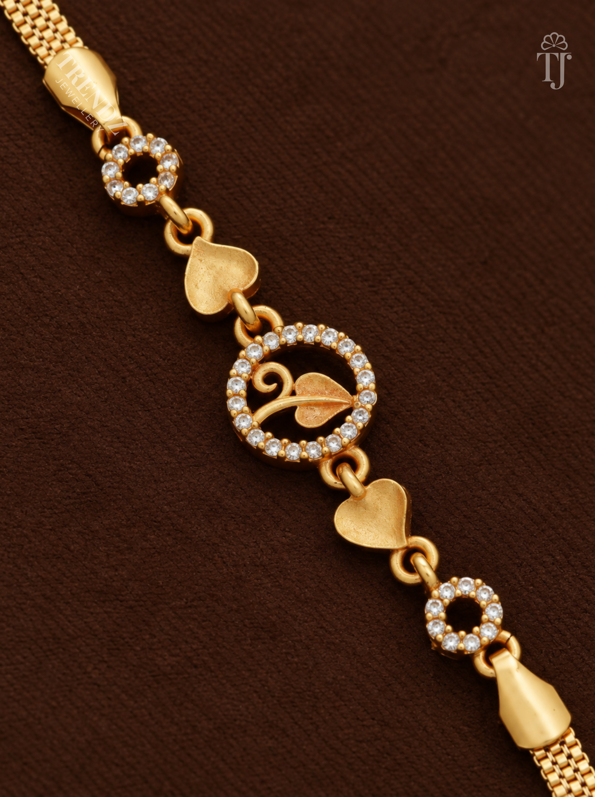 Close-up of round AD stone charm with gold leaf and heart-shaped links