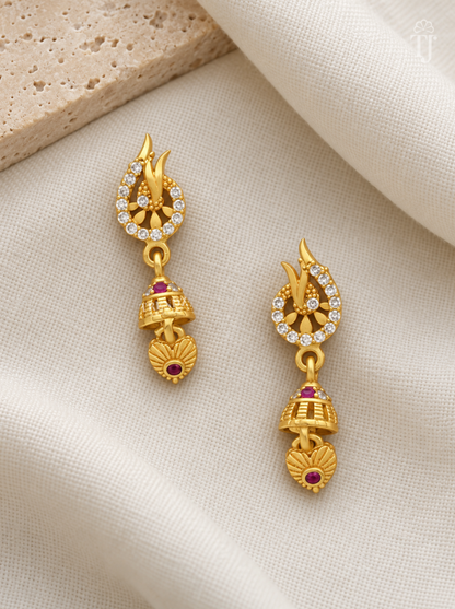 Pair of gold plated leaf tip earrings with pink stone jhumka on cream linen