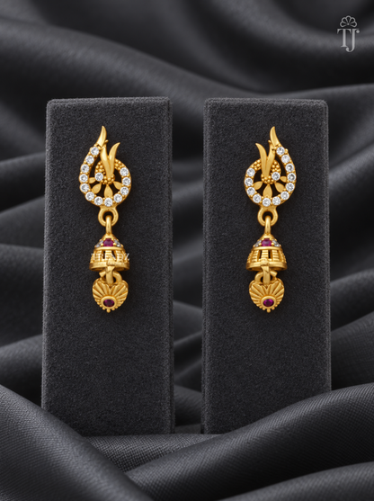 Gold plated leaf tip jhumka earrings with AD stones on black display stand
