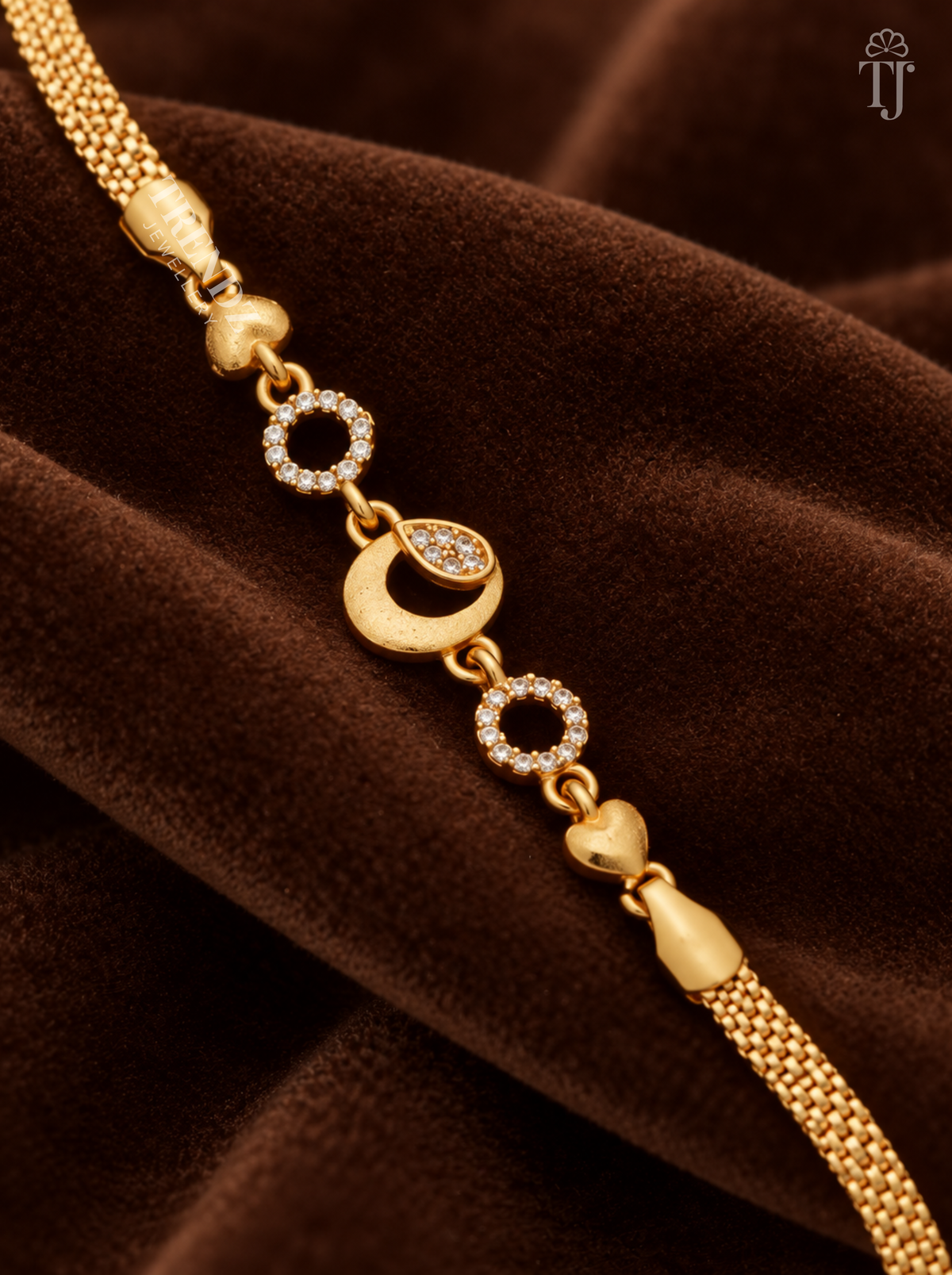 Close-up of gold moon charm with AD stone drop, stone rings and heart links