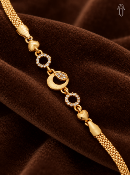 Close-up of gold moon charm with AD stone drop, stone rings and heart links