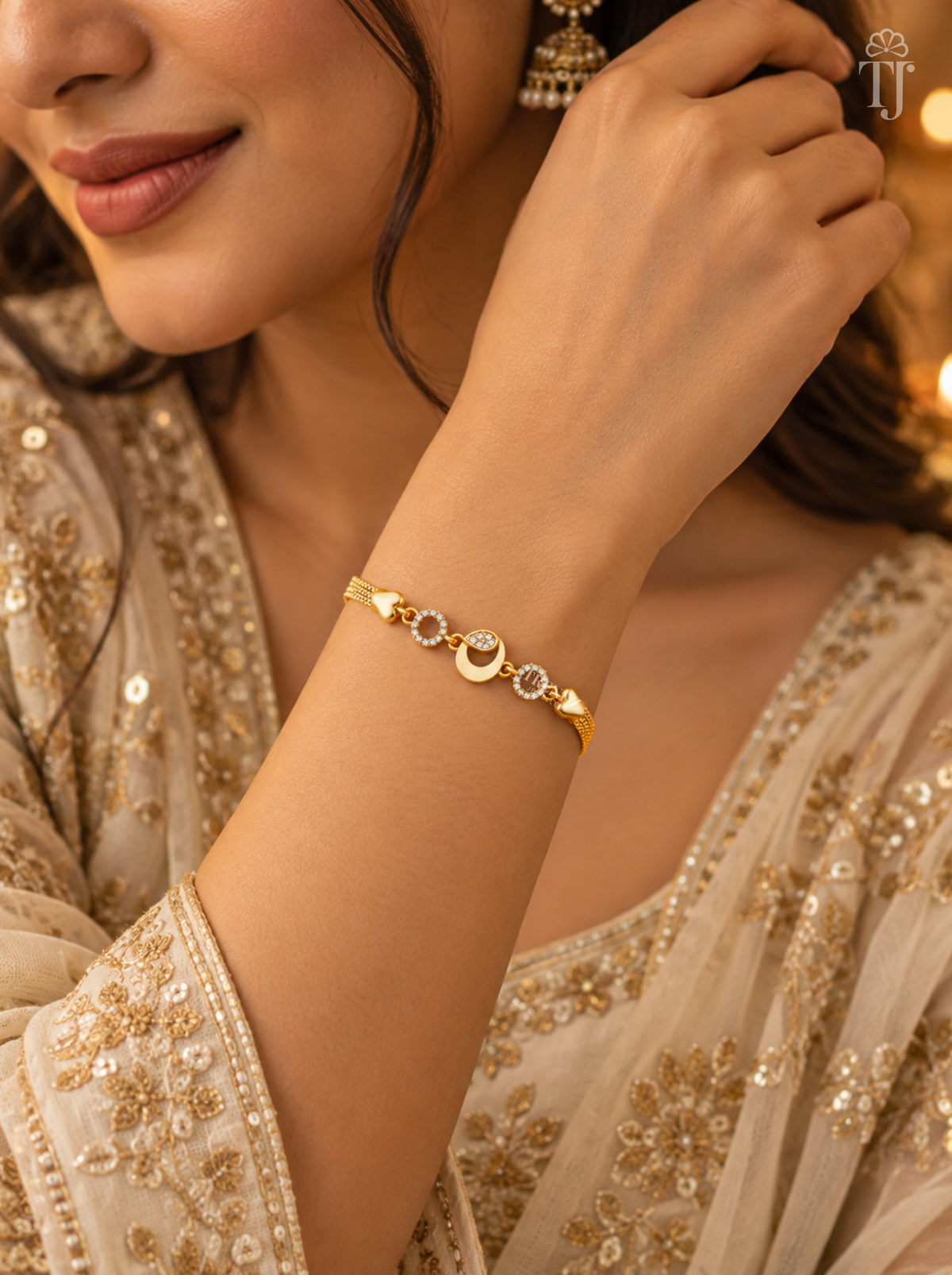 Woman in beige embroidered dress wearing gold plated moon bracelet on her wrist