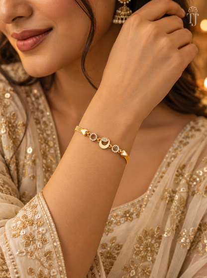 Woman in beige embroidered dress wearing gold plated moon bracelet on her wrist