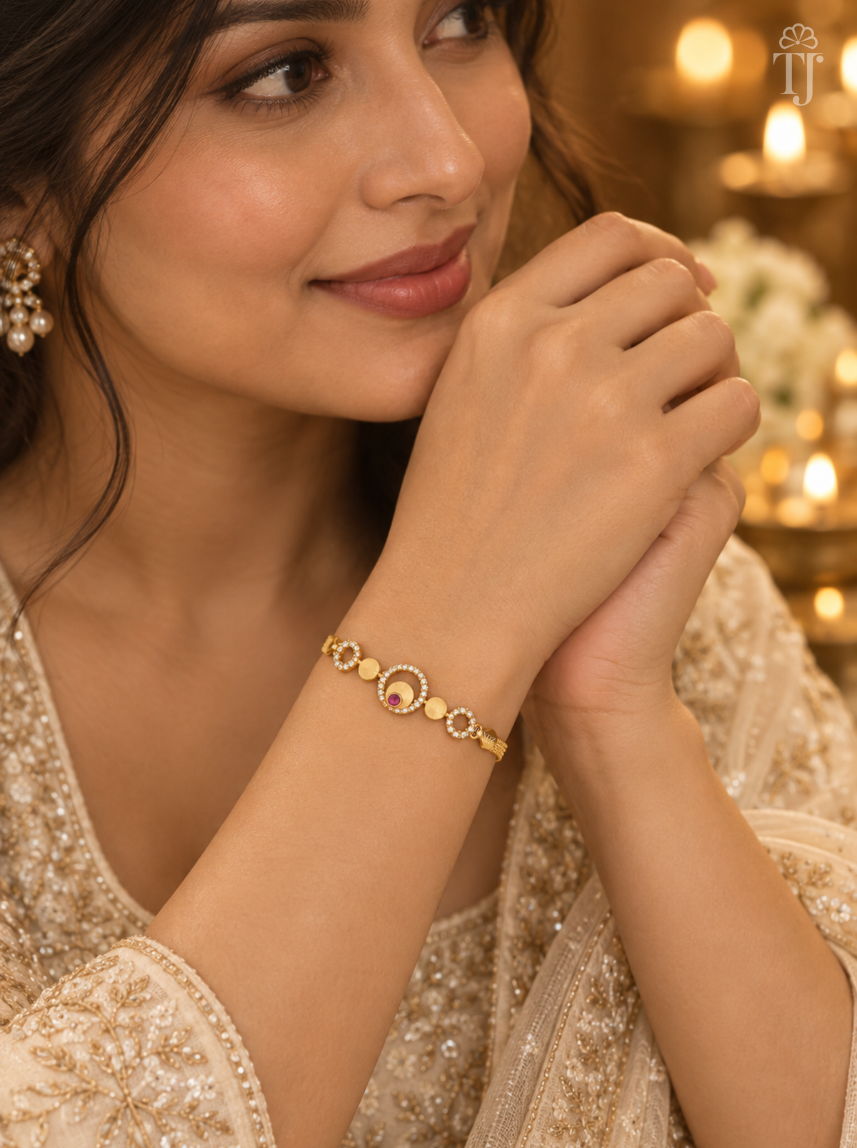 Woman in beige embroidered outfit wearing gold plated pink stone bracelet on her wrist