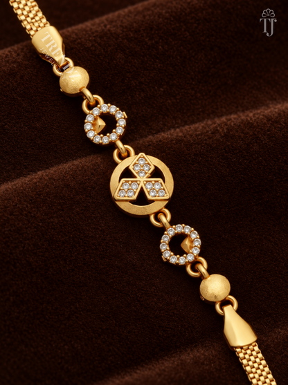 Close-up of round gold charm with three AD stone diamond shapes and stone rings