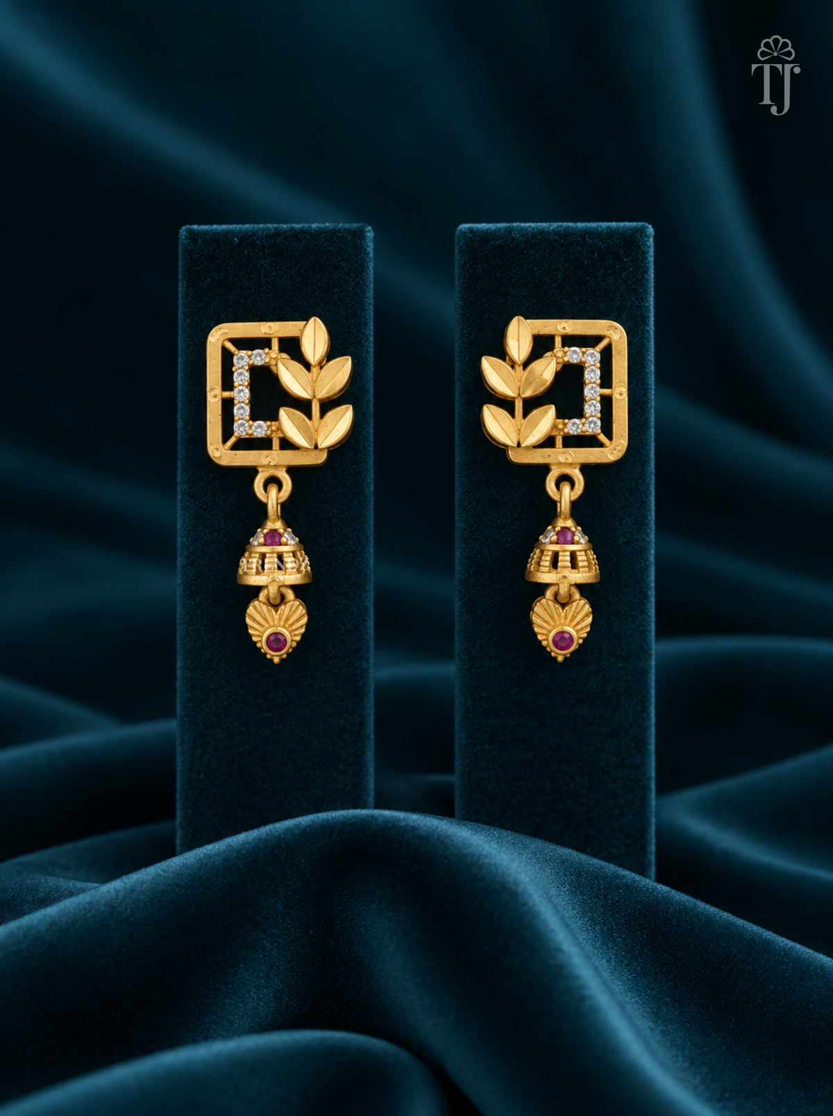 Gold plated square jhumka earrings with AD stones on teal velvet display stand