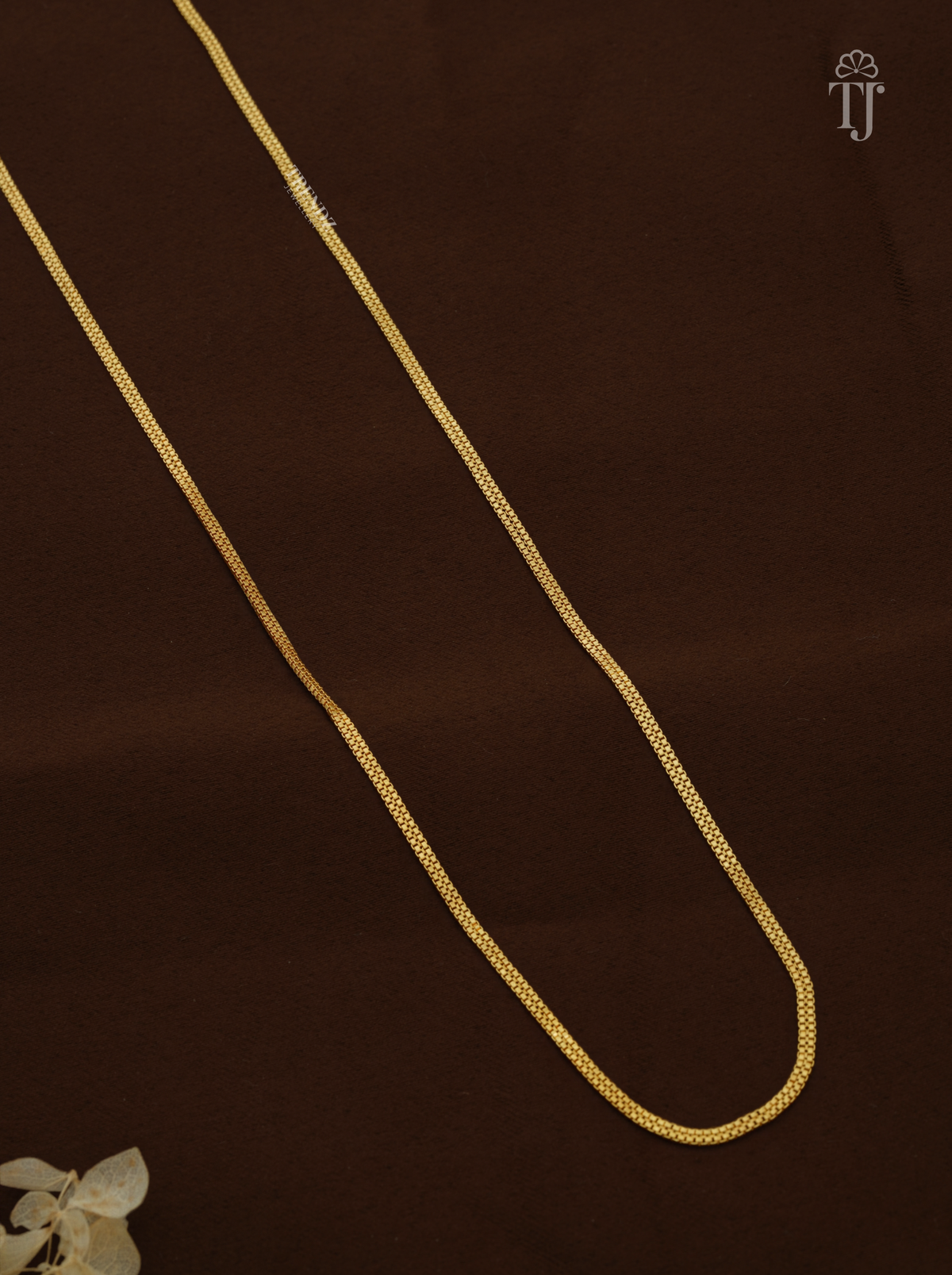 Close view of thin gold plated chain with tiny box links in a double row