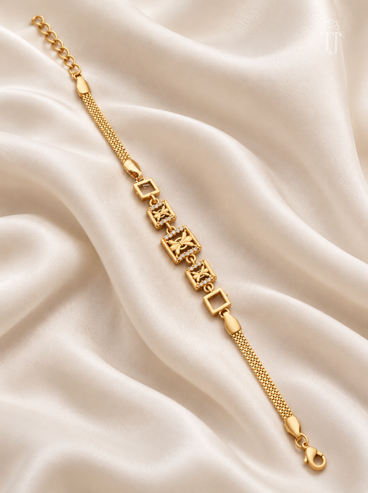 Gold plated butterfly square link bracelet for women flat lay on white silk