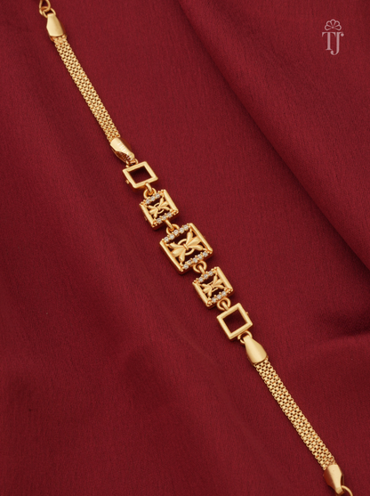Designer gold plated AD diamond bracelet for women closeup on red cloth