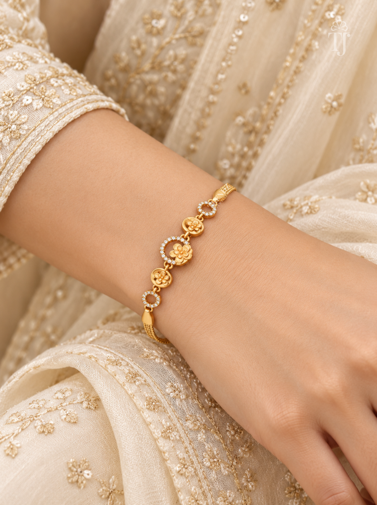 Woman wearing gold plated floral bracelet with white ethnic outfit