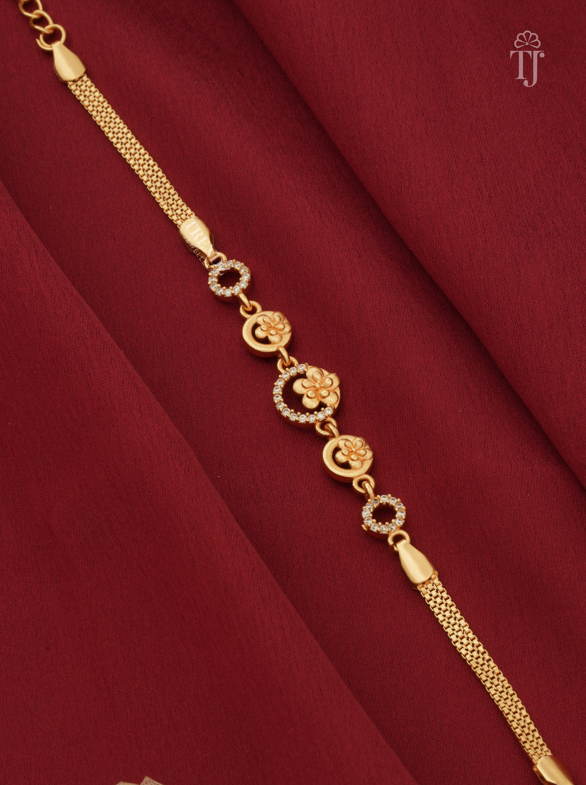 Designer floral gold plated bracelet with AD diamond on red cloth