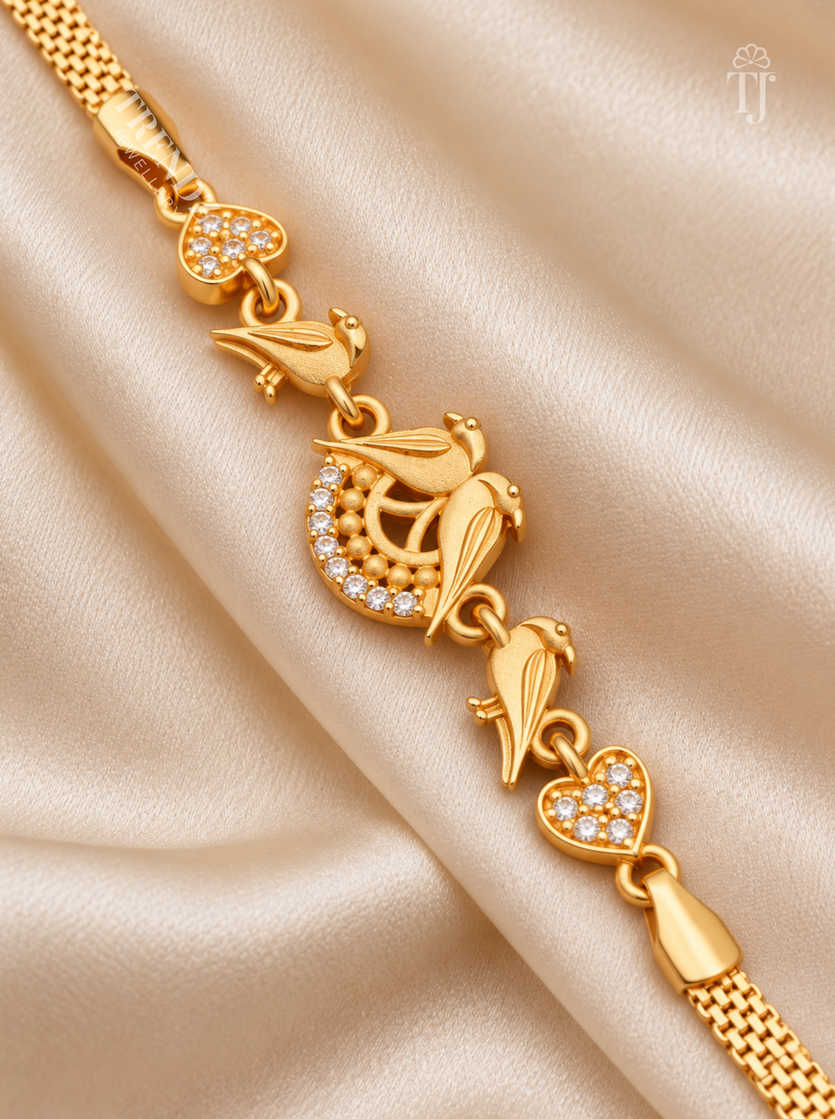 Close up of gold plated parrot bracelet with crescent moon AD diamond and heart motif