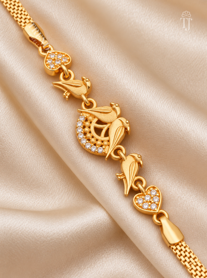 Close up of gold plated parrot bracelet with crescent moon AD diamond and heart motif