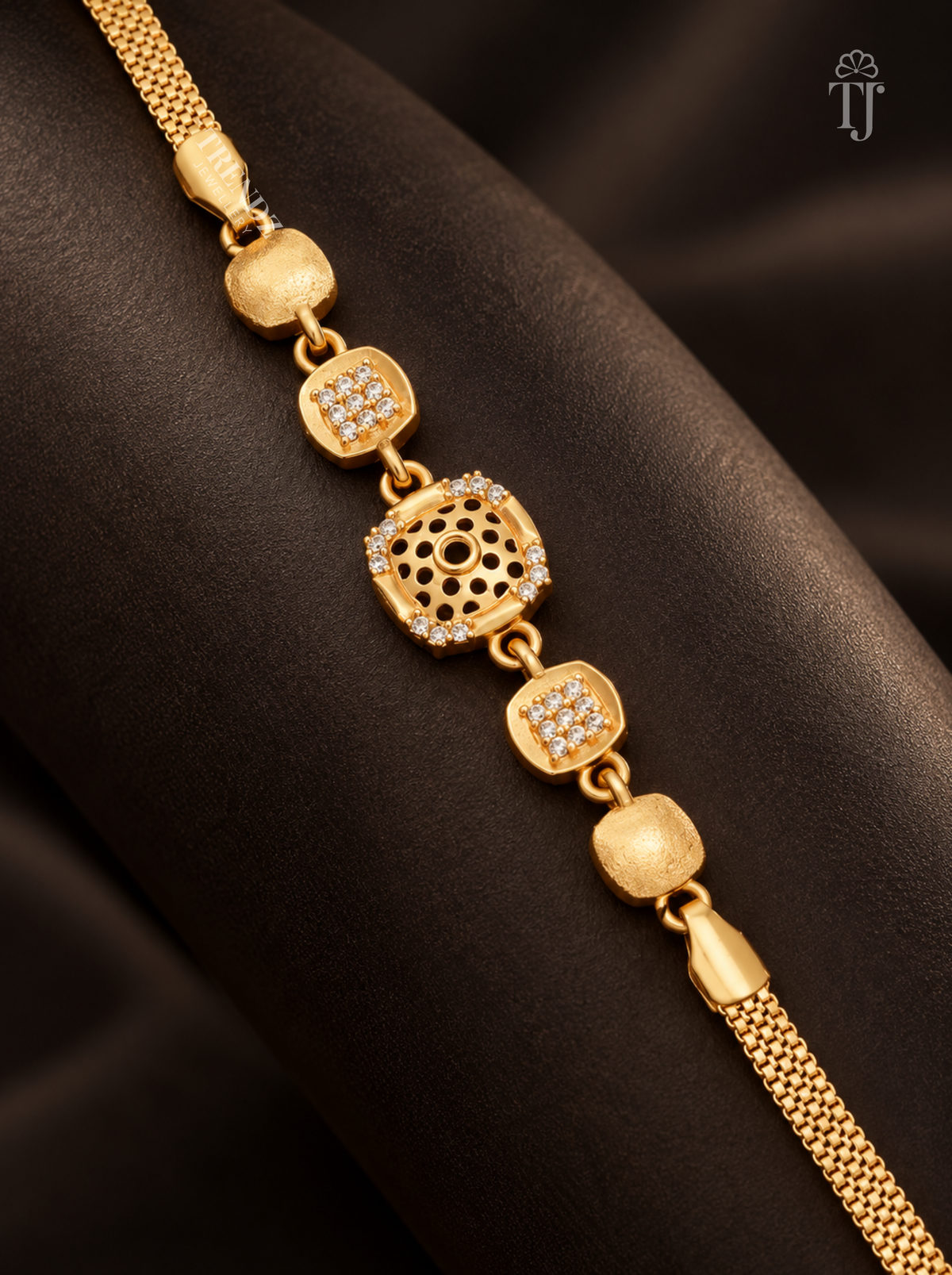 Close up of premium gold plated square bracelet with floral cutwork AD diamond on black fabric