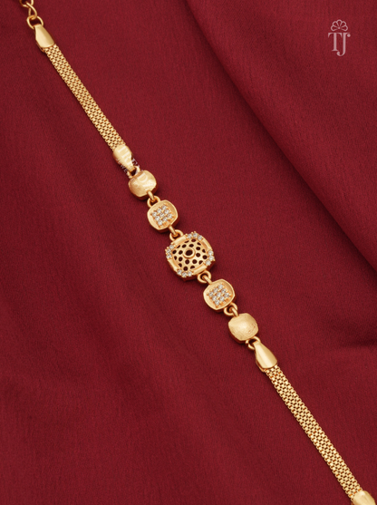 Premium gold plated square floral cutwork bracelet for girls on red fabric background
