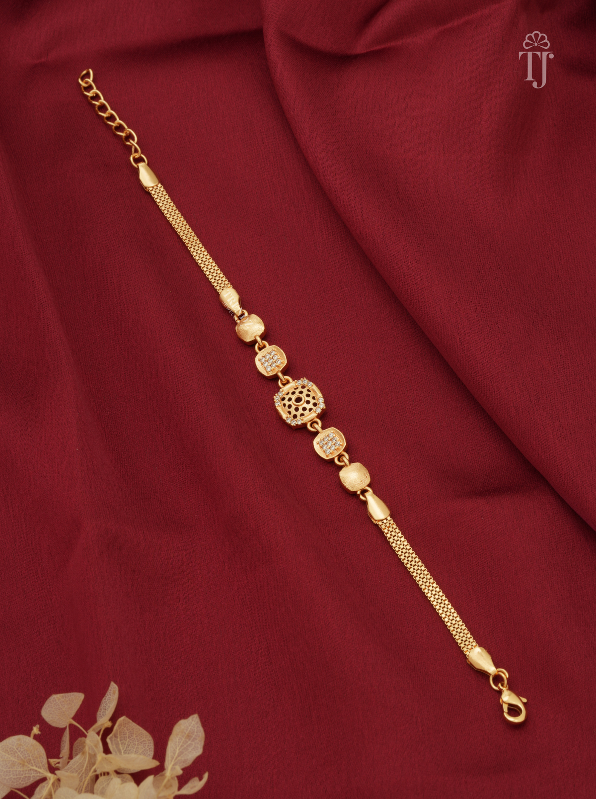 Gold plated square designer bracelet with AD diamond floral cutwork on red cloth