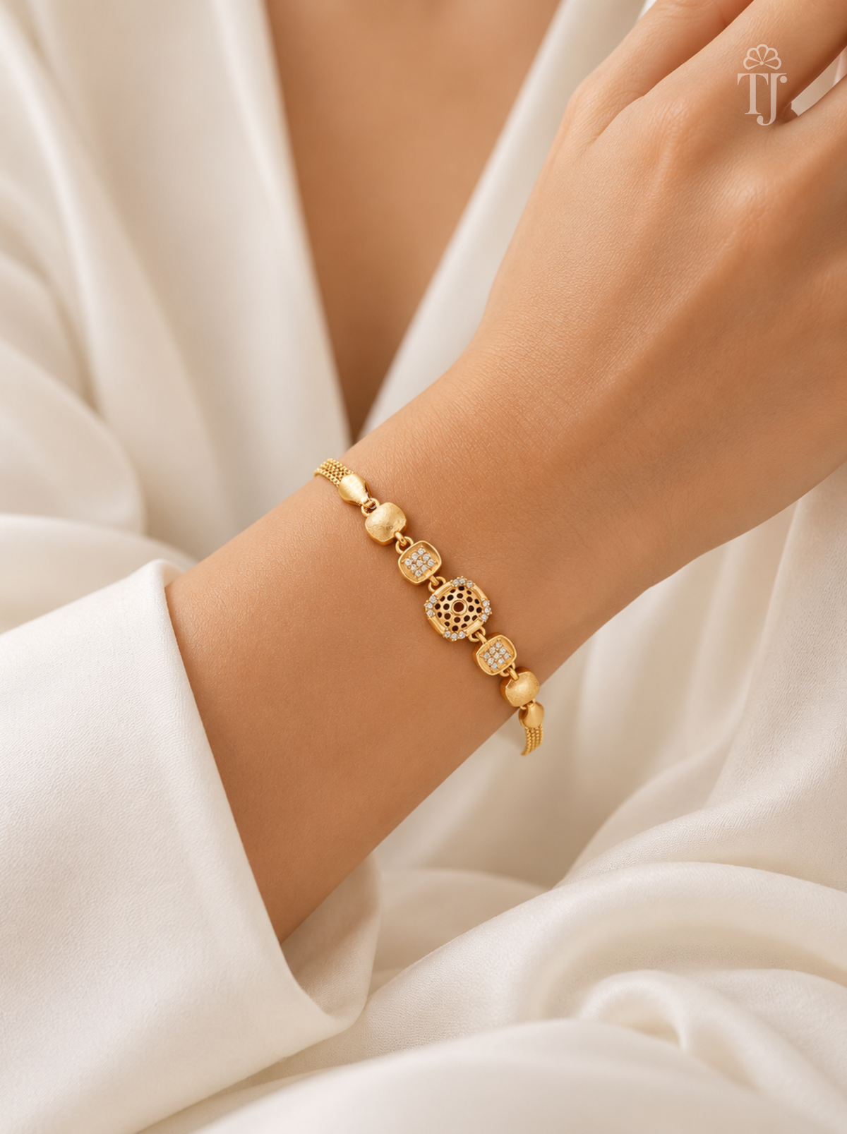 Woman wearing premium gold plated square bracelet with white saree