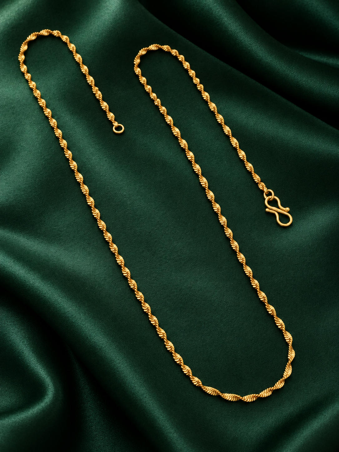 Thin twisted gold plated chain with S-hook on dark green satin