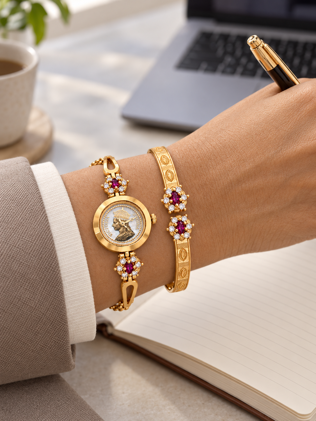 Woman writing at office desk wearing gold plated watch with kada on her wrist
